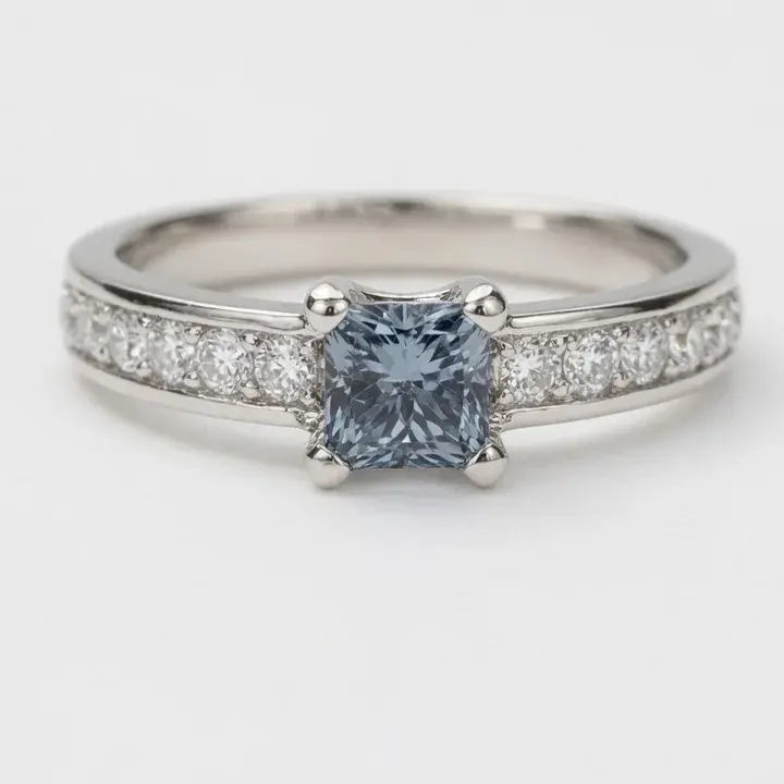 A silver ring with a square diamond and small side stones